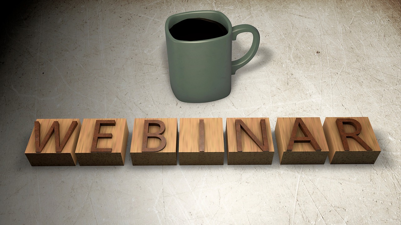 photo of webinar in block letters and cup of coffee