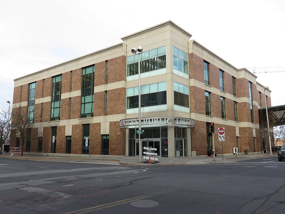 front view of Spokane Public Library building, with street in the foreground