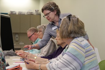 Staff person assisting at computers