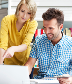 Man and woman working together at a computer