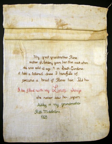 Photograph of an embroidered cotton feed sack from the mid-19th century.