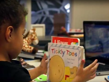 Child holding a book coole Tickly Toes