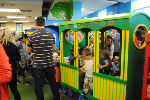 Photo of library patrons in a model train