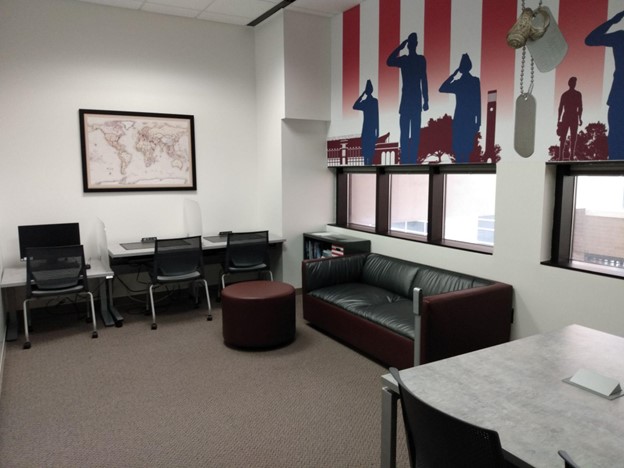 empty study room with desks and military mural