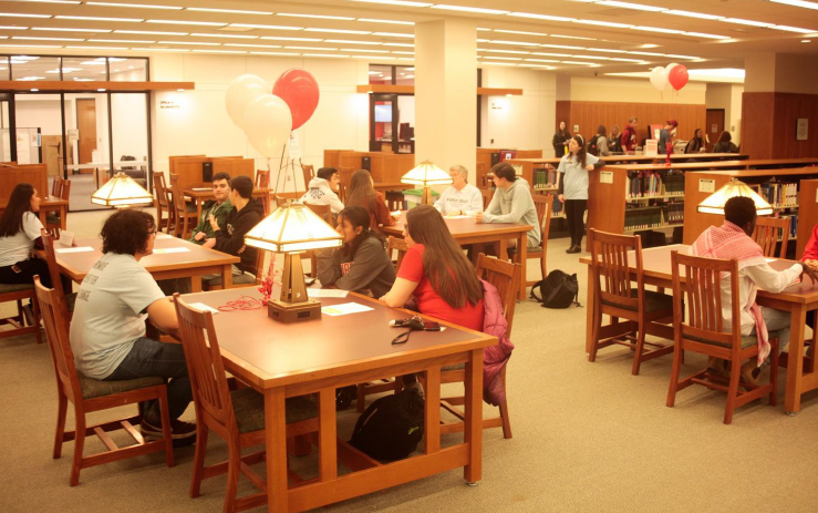 people seated at several tables for a Human Library event people seated at several tables for a Human Library event