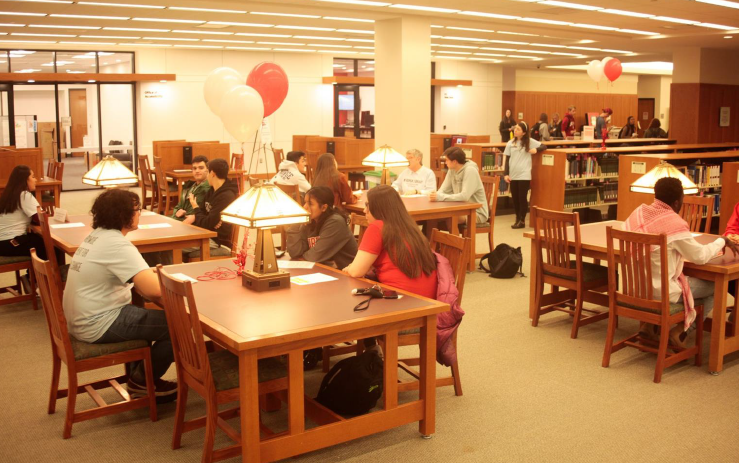 people seated at several tables for a Human Library event