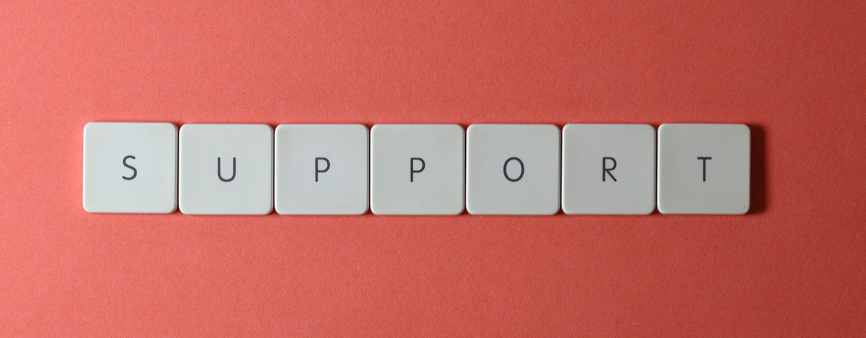 Letter tiles that spell out ‘support’