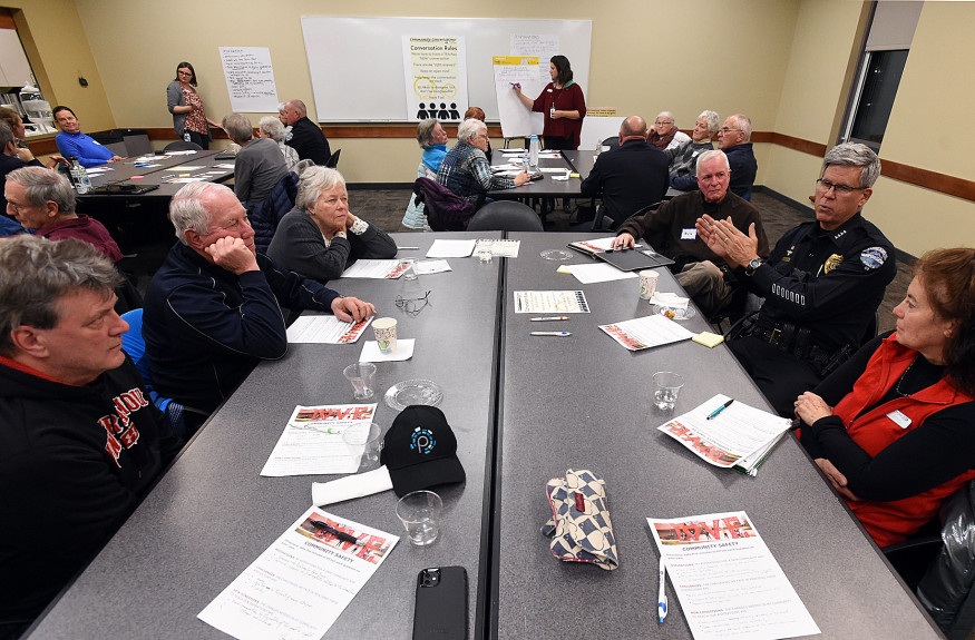 Community conversation Group of people in discussion seated around a table