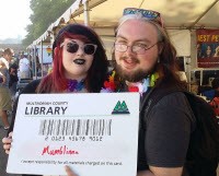 Patrons with giant library card at festival