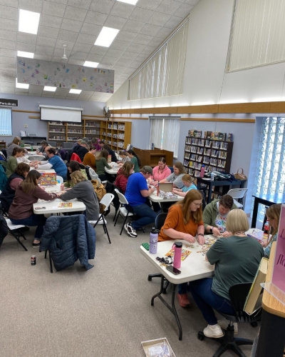 Four tables of patrons participating in program