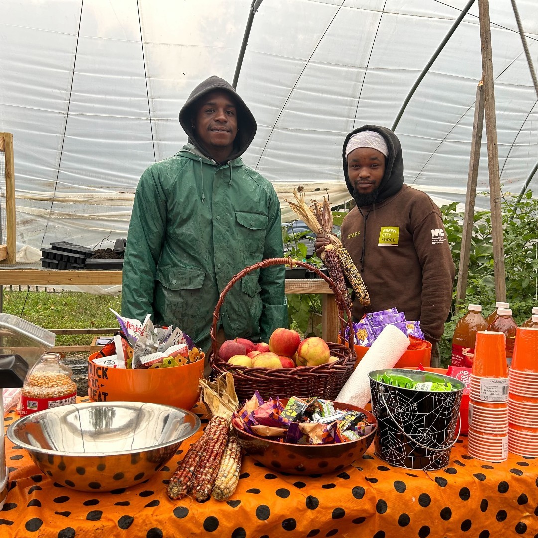Two people standing together at a fall farm stand