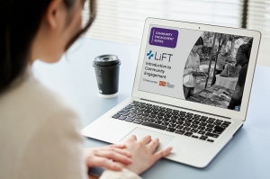 Learner with laptop open to Introduction to Community Engagement
