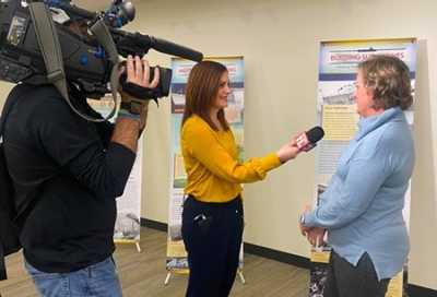 Photo: Local TV reporter covering a library event