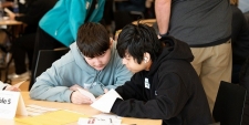 Two approximately teen aged boys playing a game
