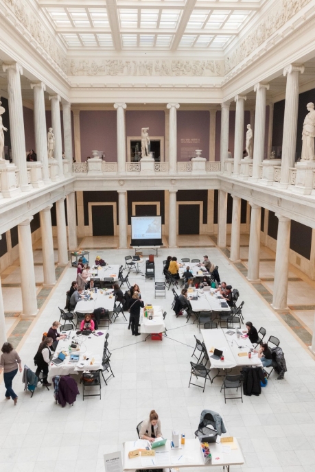 Overhead view of participants sitting at tables for a Wikipedia editing event in the Hall of Sculpture at the Carnegie Museum of Art.