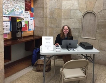 MSLL-LL-reference Librarian sitting at a table with resources