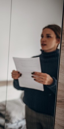 Female practicing her speech in advance in a mirror