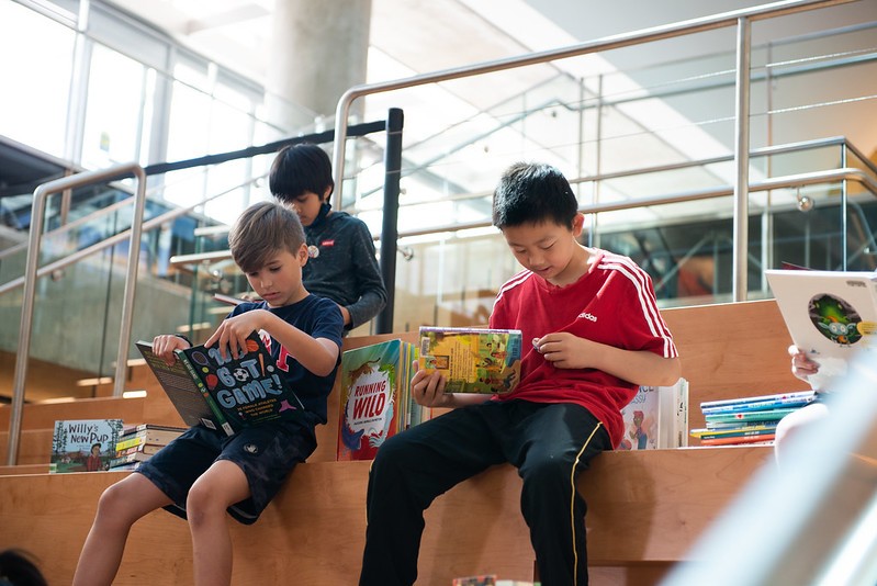 Summer Reading Club kids reading on steps, British Columbia
