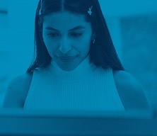 headshot of a woman working on a laptop