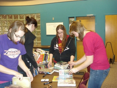 Teens help with a weeding project.