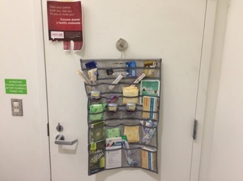 Photo of hygiene products hanging from an organizer on a door.